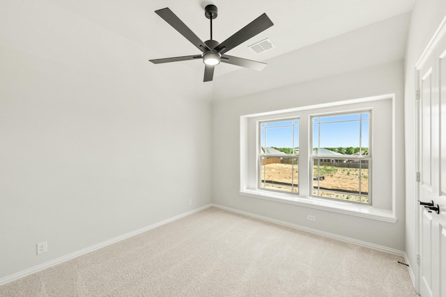 unfurnished room with visible vents, light colored carpet, baseboards, and ceiling fan