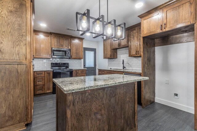 kitchen with dark hardwood / wood-style flooring, light stone counters, tasteful backsplash, and black electric range