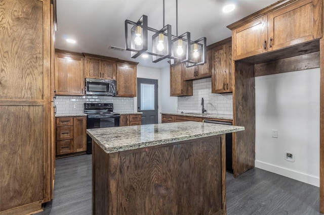 kitchen with stainless steel microwave, visible vents, a kitchen island, black range with electric cooktop, and a sink