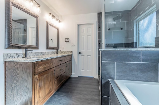 bathroom featuring vanity, hardwood / wood-style flooring, and independent shower and bath