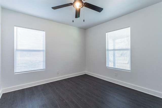 empty room with dark hardwood / wood-style floors and ceiling fan