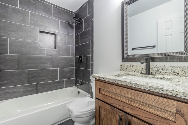 full bathroom with vanity, toilet, and tiled shower / bath