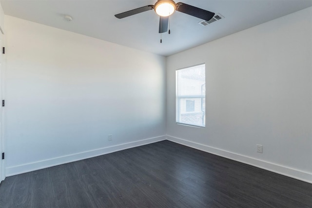 empty room with ceiling fan and dark wood-type flooring