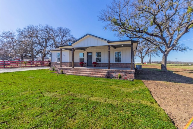 view of front of house with covered porch and a front lawn