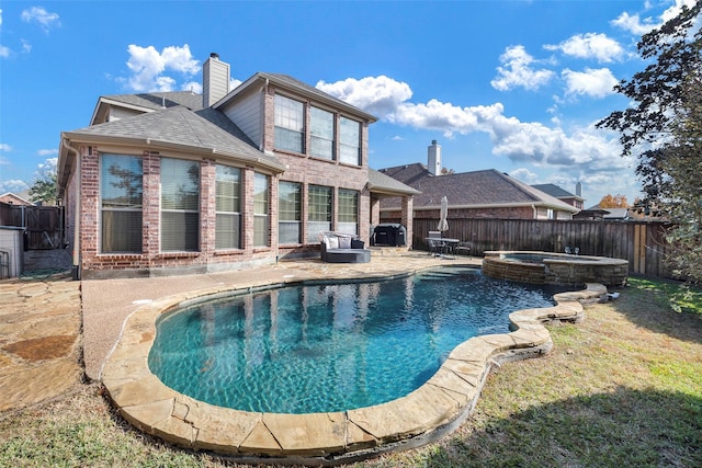 view of pool with a patio, a pool with connected hot tub, and a fenced backyard