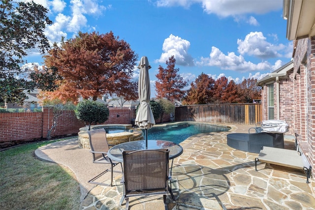 view of swimming pool with an in ground hot tub and a patio