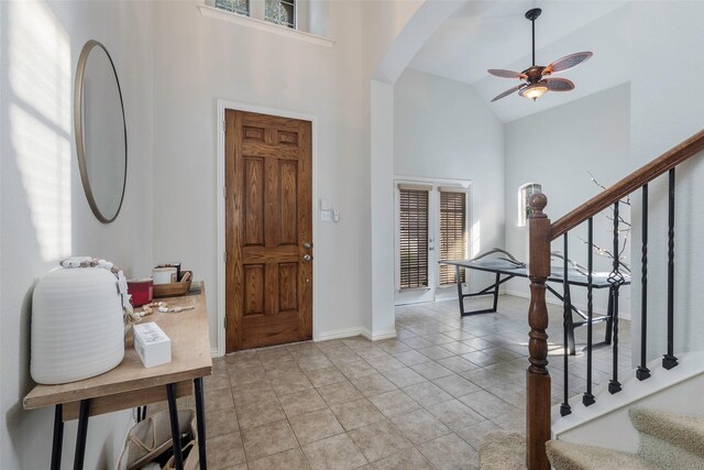 playroom with ceiling fan, tile patterned floors, and vaulted ceiling