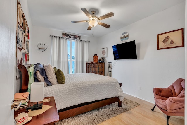 bedroom with hardwood / wood-style floors and ceiling fan