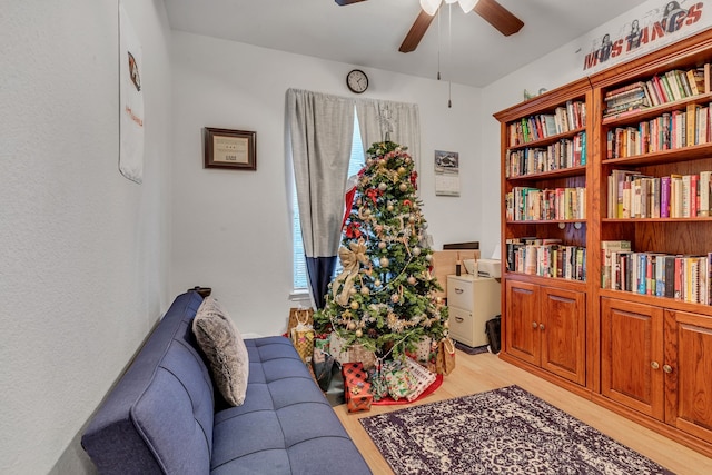 sitting room featuring ceiling fan and light wood-type flooring