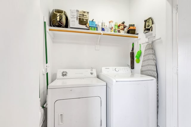 clothes washing area featuring washer and clothes dryer