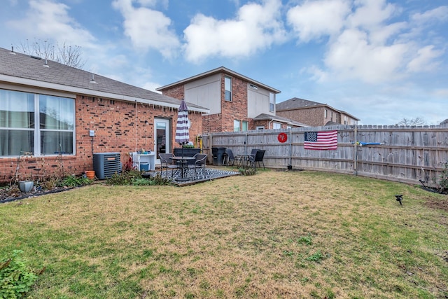 view of yard featuring central air condition unit and a patio