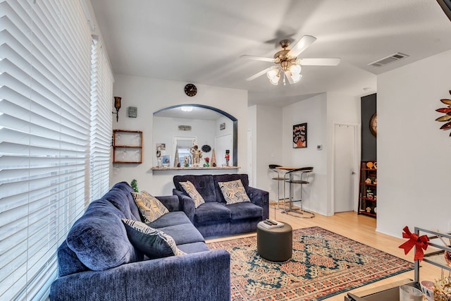 living room with hardwood / wood-style floors and ceiling fan