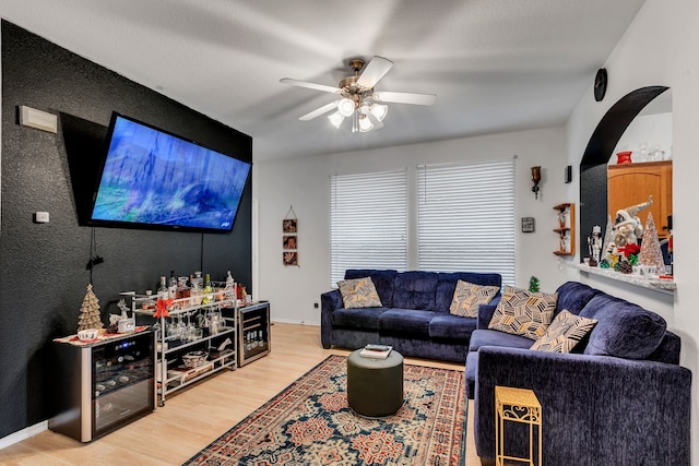 living room with hardwood / wood-style floors and ceiling fan