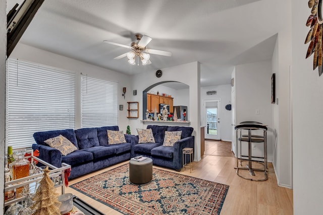 living room with ceiling fan and light wood-type flooring