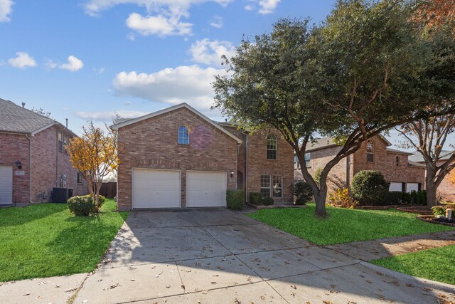 front facade with a front yard, a garage, and central AC unit