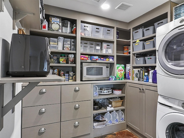 laundry room with stacked washer / drying machine