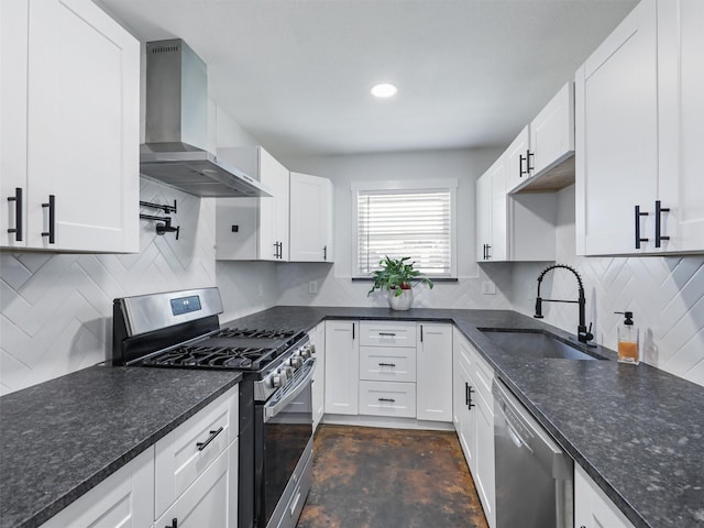 kitchen featuring tasteful backsplash, white cabinetry, sink, stainless steel appliances, and wall chimney exhaust hood