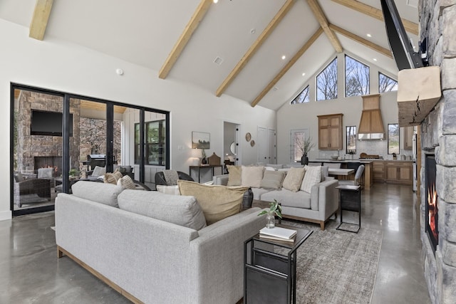 living room with beam ceiling, a fireplace, and high vaulted ceiling