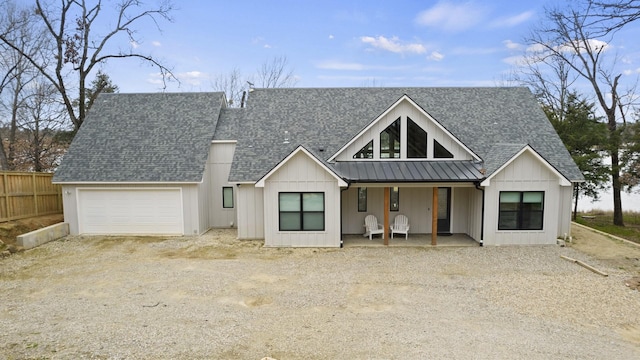 modern farmhouse style home featuring a porch and a garage