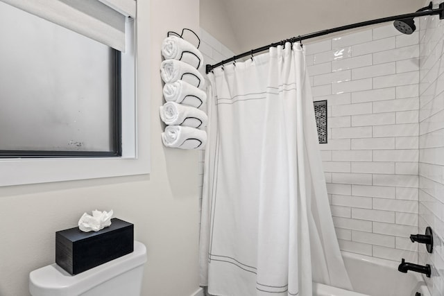 bathroom with toilet and shower / tub combo with curtain