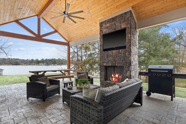 view of patio / terrace with an outdoor living space with a fireplace, ceiling fan, and grilling area