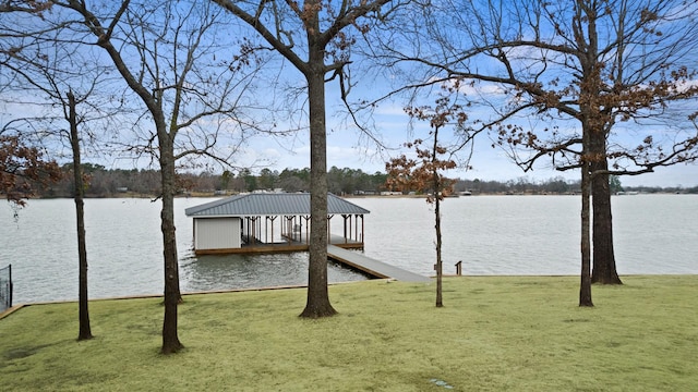 dock area featuring a lawn and a water view