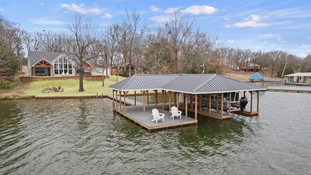 view of dock with a yard and a water view