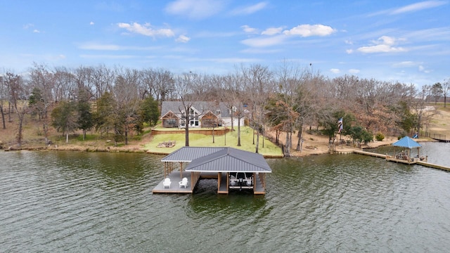 dock area with a yard and a water view