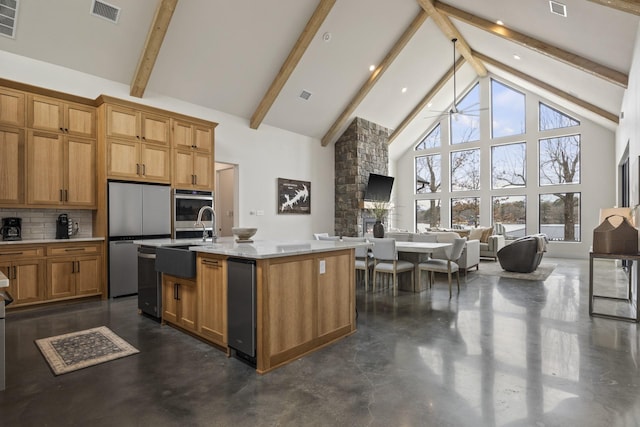 kitchen featuring beam ceiling, a kitchen island with sink, high vaulted ceiling, and stainless steel appliances