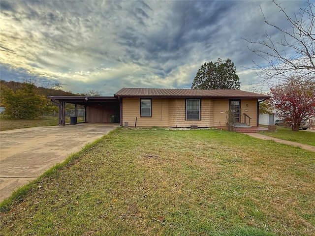 view of front of property with a front lawn and a carport