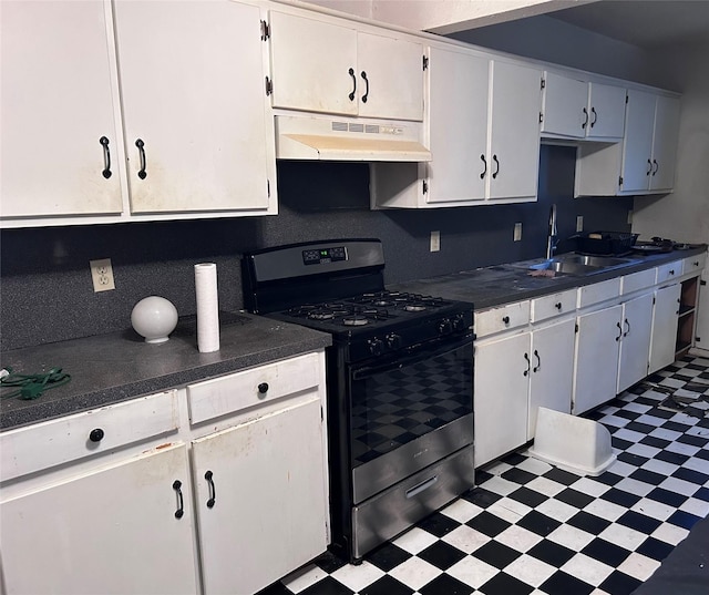 kitchen with gas range, white cabinetry, and sink