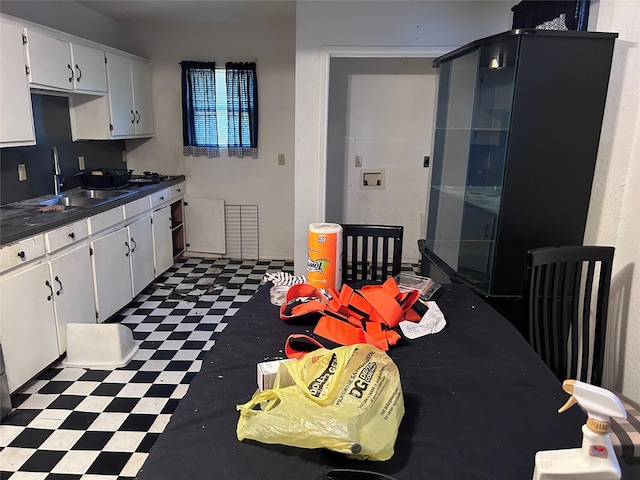 kitchen with white cabinetry and sink