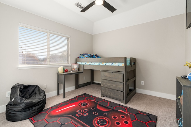 carpeted bedroom with ceiling fan and vaulted ceiling