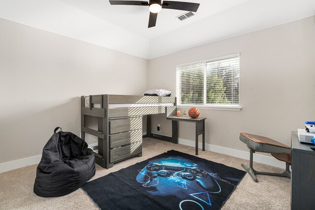 exercise room featuring ceiling fan, vaulted ceiling, and carpet flooring