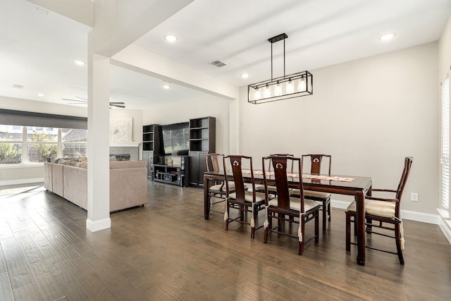 dining space with dark hardwood / wood-style floors and ceiling fan