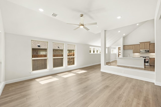 unfurnished living room featuring light wood finished floors, ceiling fan, lofted ceiling, and visible vents