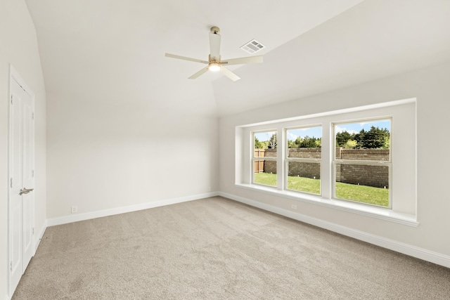empty room with baseboards, carpet flooring, ceiling fan, and visible vents