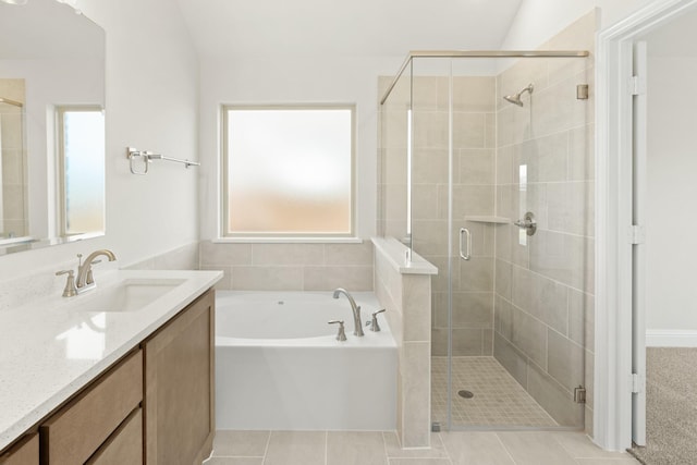 full bathroom featuring vanity, a bath, and a stall shower