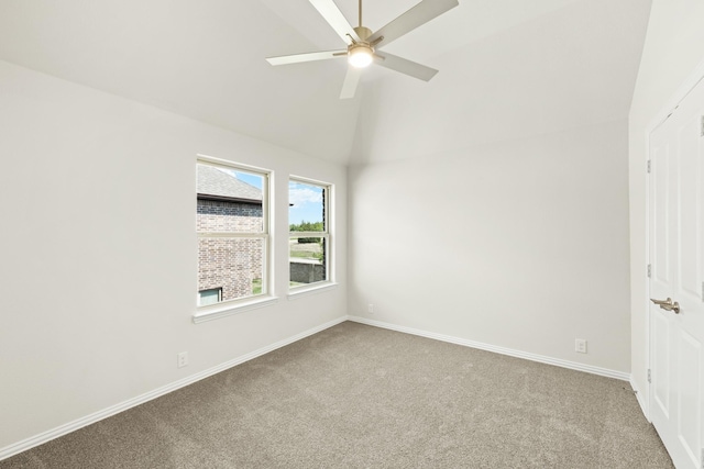 carpeted empty room featuring high vaulted ceiling, baseboards, and a ceiling fan