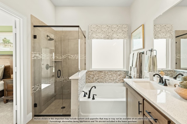 bathroom featuring vanity and shower with separate bathtub