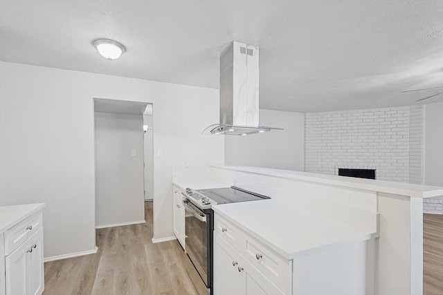 kitchen with kitchen peninsula, extractor fan, electric range, light hardwood / wood-style flooring, and white cabinets