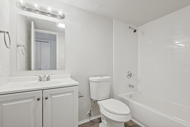 full bathroom with a textured ceiling, vanity, hardwood / wood-style flooring, toilet, and tiled shower / bath