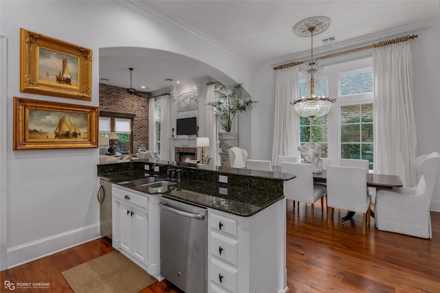 kitchen featuring sink, white cabinetry, dark hardwood / wood-style flooring, decorative light fixtures, and stainless steel dishwasher