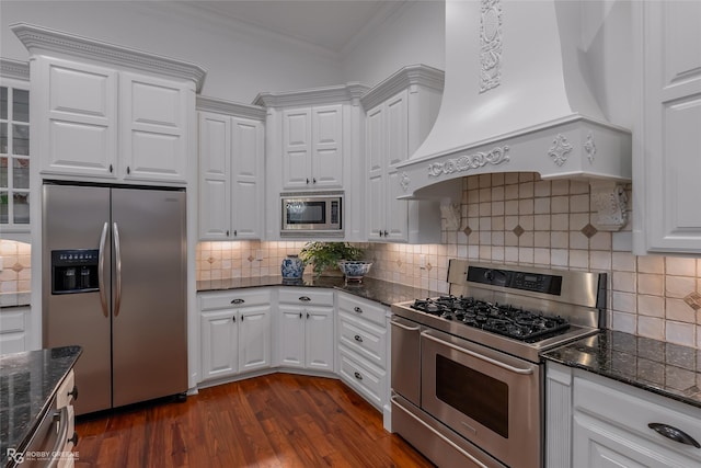 kitchen featuring stainless steel appliances, custom exhaust hood, and white cabinetry