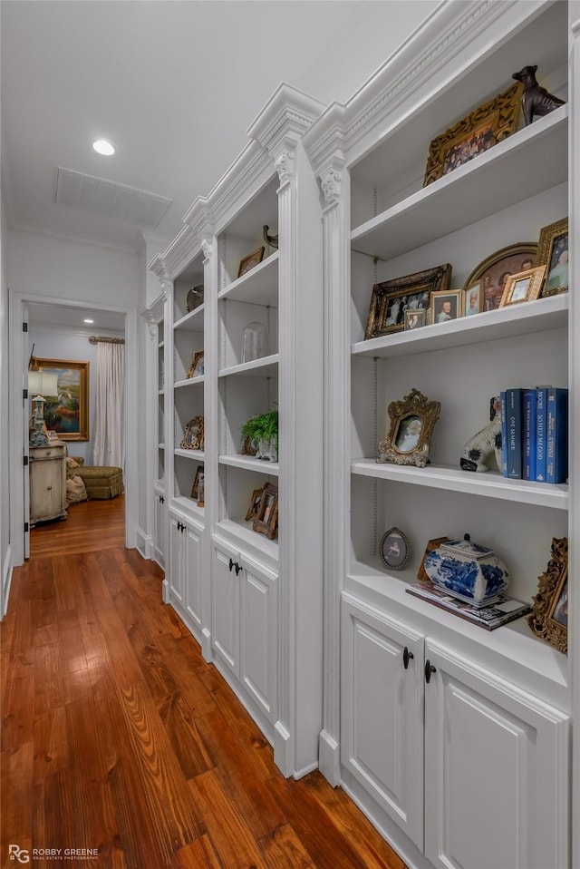 corridor featuring hardwood / wood-style flooring and crown molding