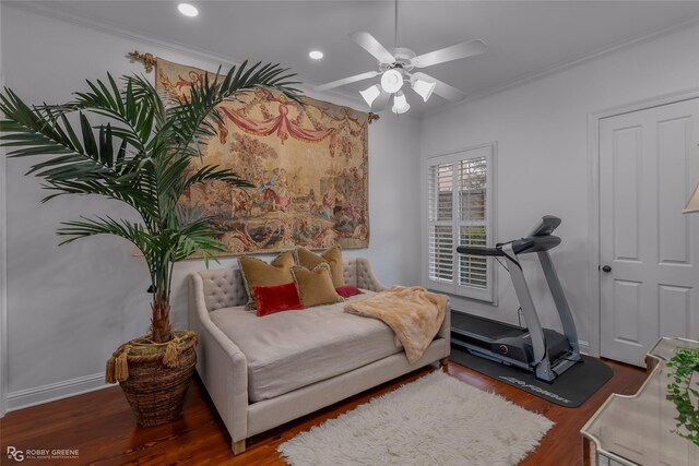 bedroom with crown molding, ceiling fan, and dark hardwood / wood-style flooring