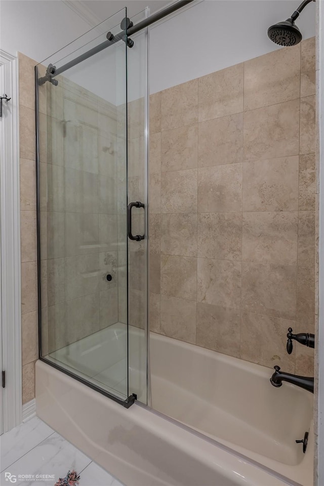 bathroom featuring combined bath / shower with glass door