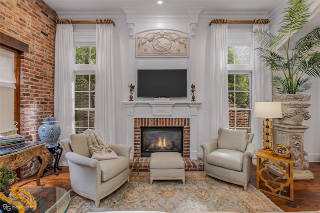 living area featuring ornamental molding, plenty of natural light, and hardwood / wood-style floors