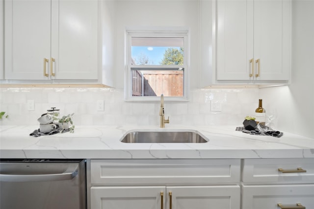 kitchen with dishwasher, backsplash, sink, light stone counters, and white cabinetry