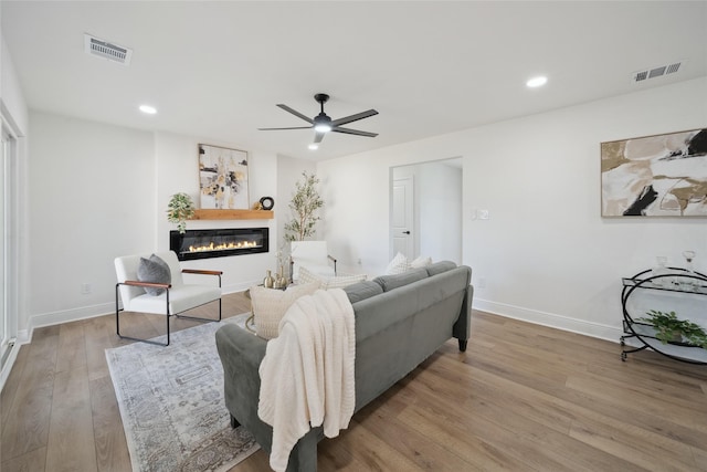 living room with hardwood / wood-style floors and ceiling fan